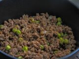 Close-up of a savory dish with minced meat and peas, ideal for culinary themes.