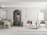 Two people in a modern, minimalist open-plan living space.