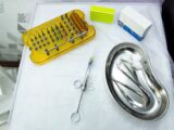 A set of dental and medical tools on a sterile tray, ideal for clinical and healthcare settings.