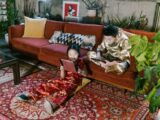 Two kids enjoying tablets on a colorful rug in a cozy living room setting.